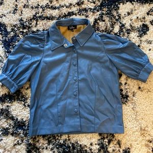 Lulu’s denim blue vegan leather blouse.
